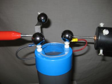 The high voltage probes touching the output terminals for 
      testing the positive/negative Cockroft-Walton voltage multiplier
      boards.