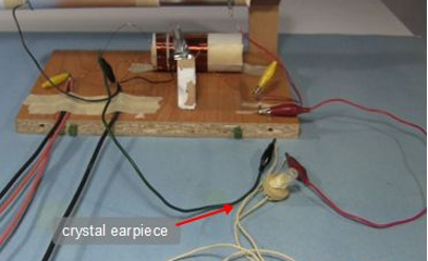 Crystal radio with crystal earpiece.