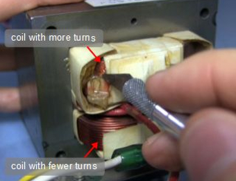 Photo of a transformer showing the coils with more and fewer turns.