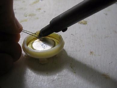 Soldering diode to piezoelectric disk.