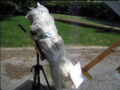 The completed solar tower wrapped in insulation with plastic wrapped around that.