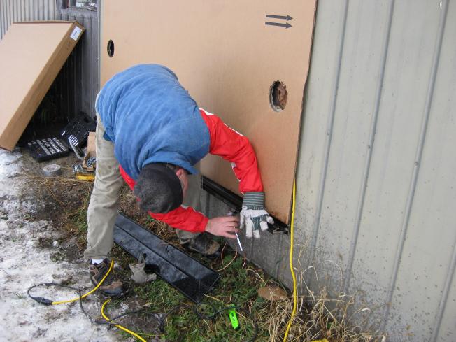 Bolting a bracket to the wall.