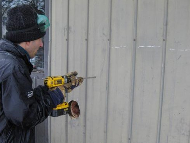 Drilling a hole to the thermostat wire.