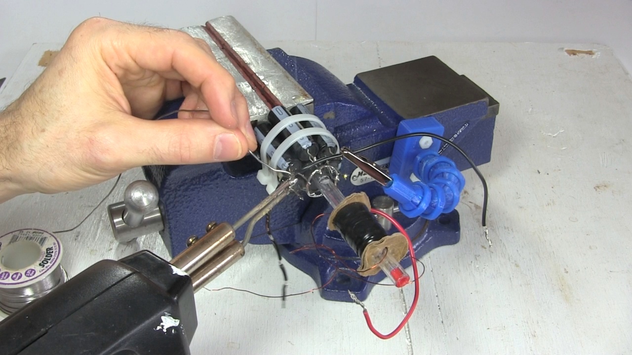 3D printed helping hands holding a wire during soldering.