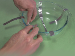 5. Taping the short strips in place for the ball cyclotron/
      electrostatic accelerator.