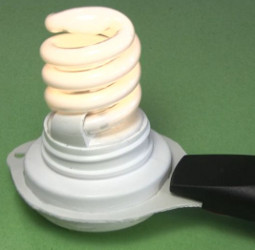 The CFL in place, hiding the wires going to the electric fly
      swatter.