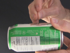 Making a second hold in the other side of the soda can using the needle.