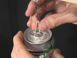 Putting the loop of string under the tab at the top of the soda can.