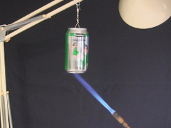 Closer view of the torch flame heating up the bottom of the soda can.