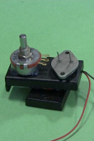 Hot glued transistor and potentiometer to battery case.