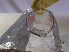 Paper towel folded and being soaked with electrolyte.