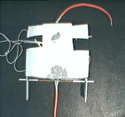 Top view of the high K dielectric polysulfide propulsion 
      device showing the small gap between the brass wire and the sealant.