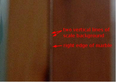 Looking through the slit at the test object while testing
      for gravitational effect for the non-conventional
      propulsion experiment involving a charged rotating cylinder.