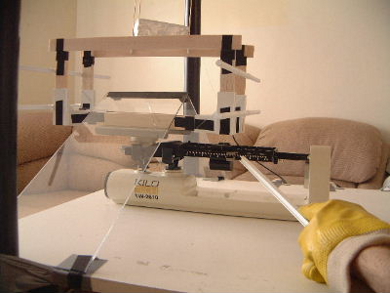 Picture of me using a long plastic rod to manipulate the scale during the experiment to measure the weight.